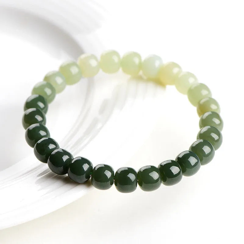 Polished Hetian jade bracelet with gradient clear water colour and round beads.