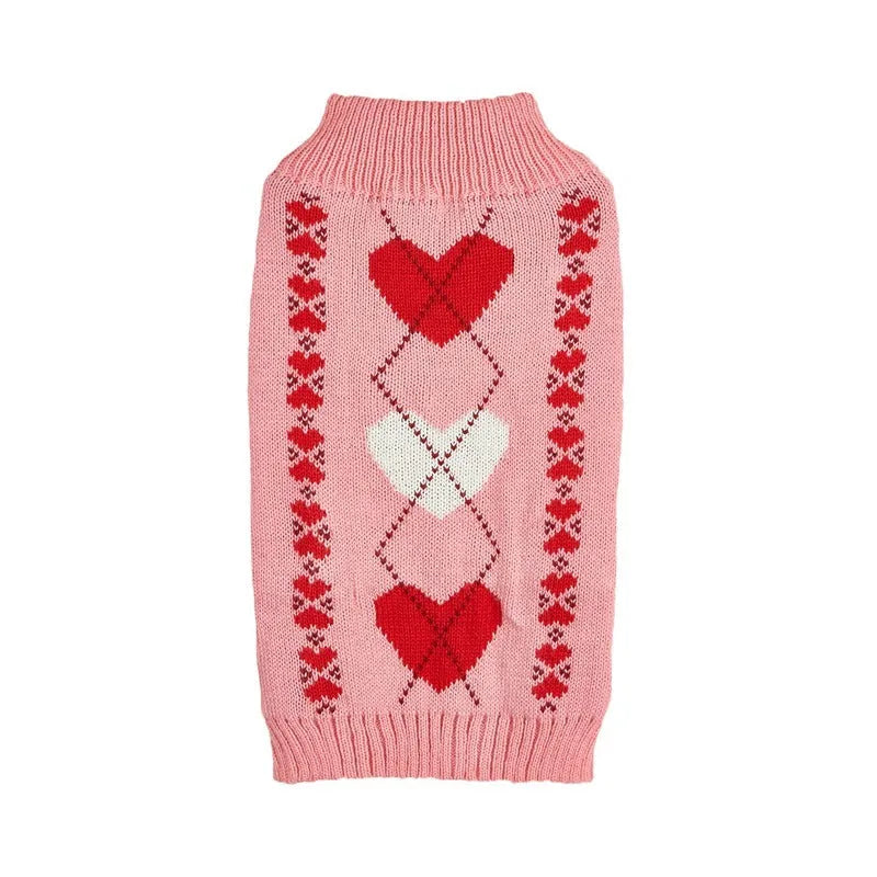 Red knitted dog jumper with a white love heart and bow design on a small dog
