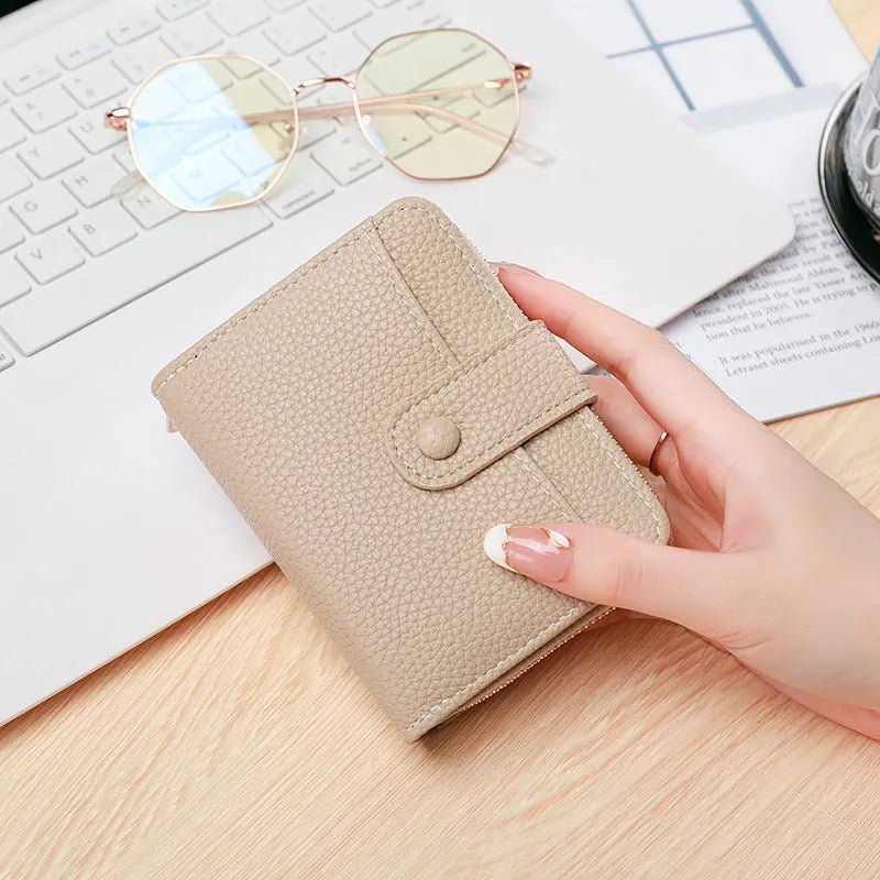 Ladies short wallet with lychee pattern in two-fold design, available in beige, pink, black, and red colours