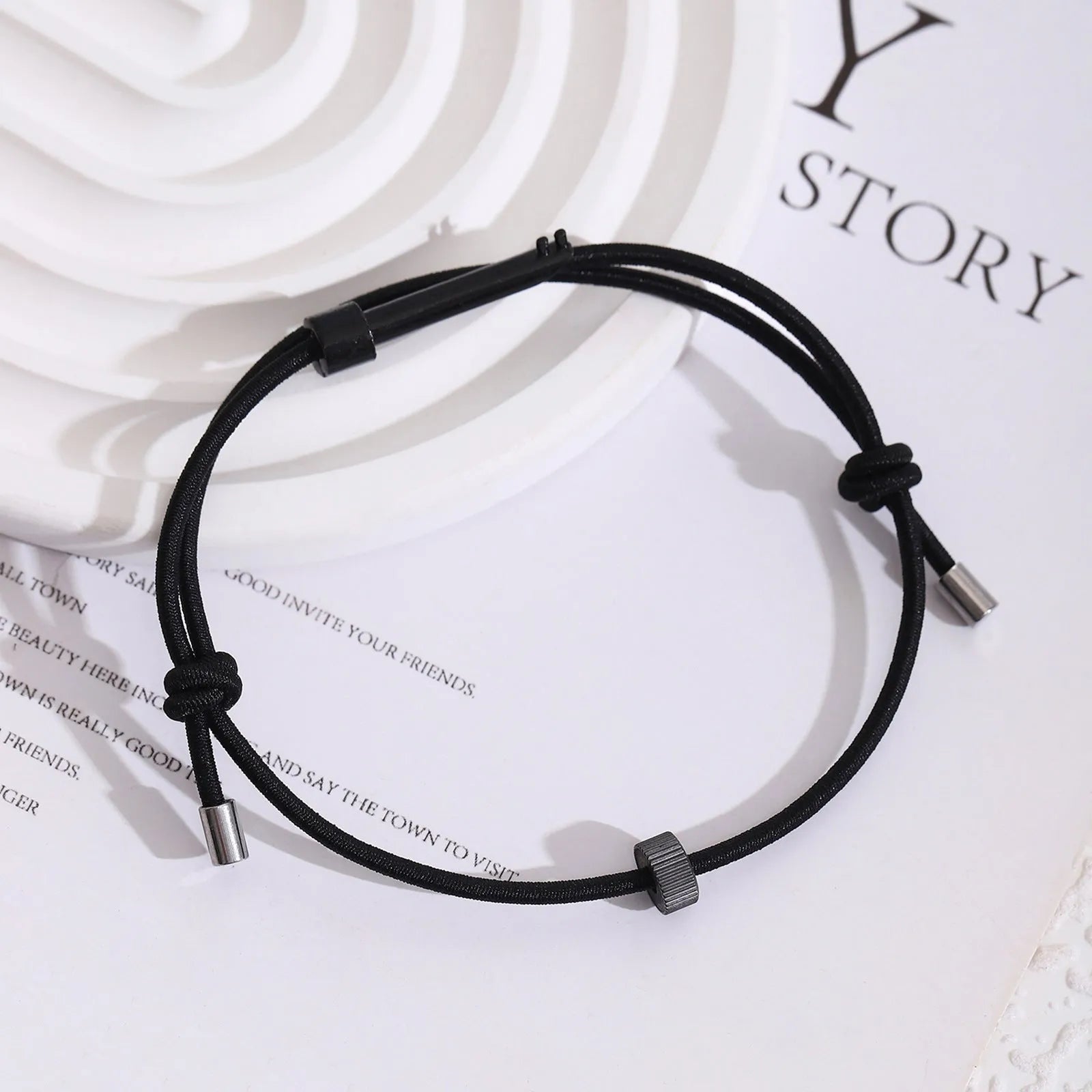 Tungsten carbide adjustable emergency escape bracelet with window breaker tip on grey background