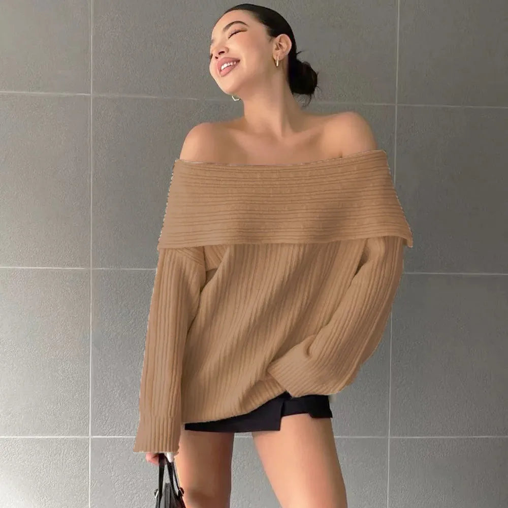 A woman wearing a loose, long-sleeved acrylic pullover sweater in a neutral colour.