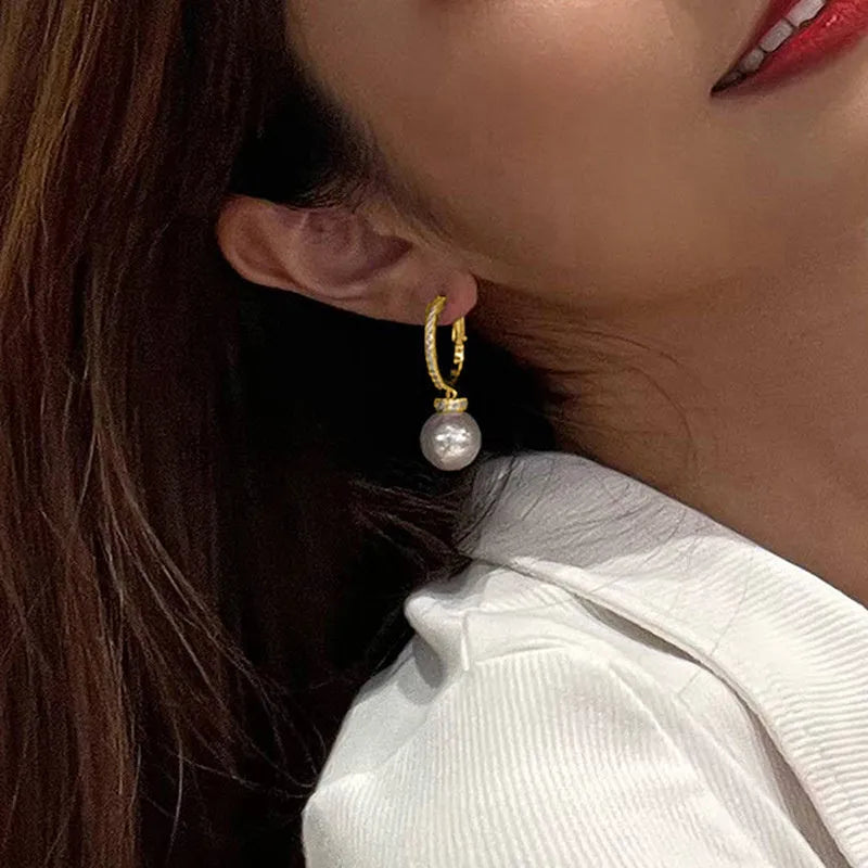 Yellow gold finish earrings with imitation pearls and inlaid zircon on copper base