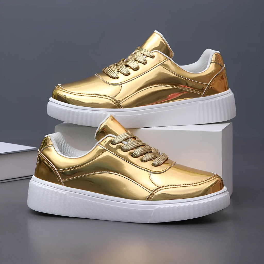 Gold sequinned platform sneakers with round toe and thick MD sole on white background.