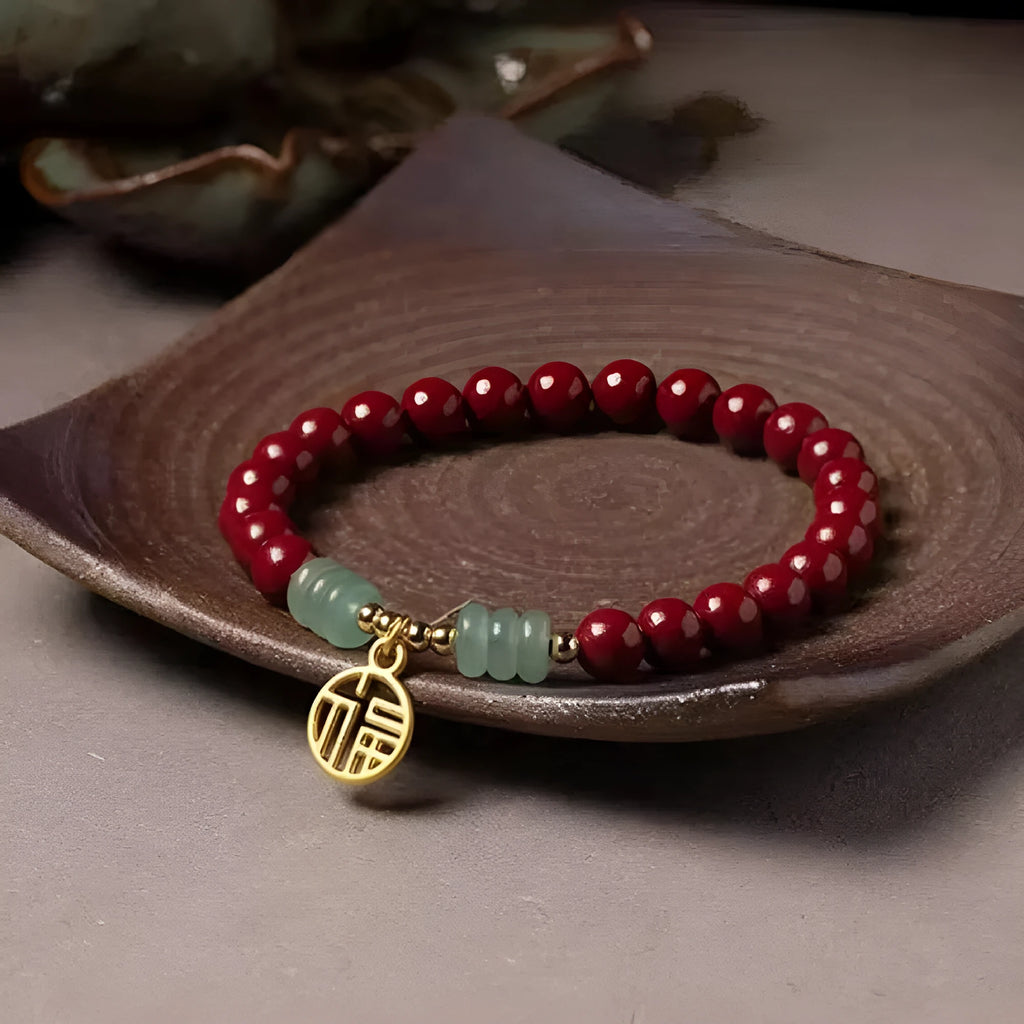 Close-up of a handcrafted wave-pattern bracelet made from red cinnabar and copper beads.
