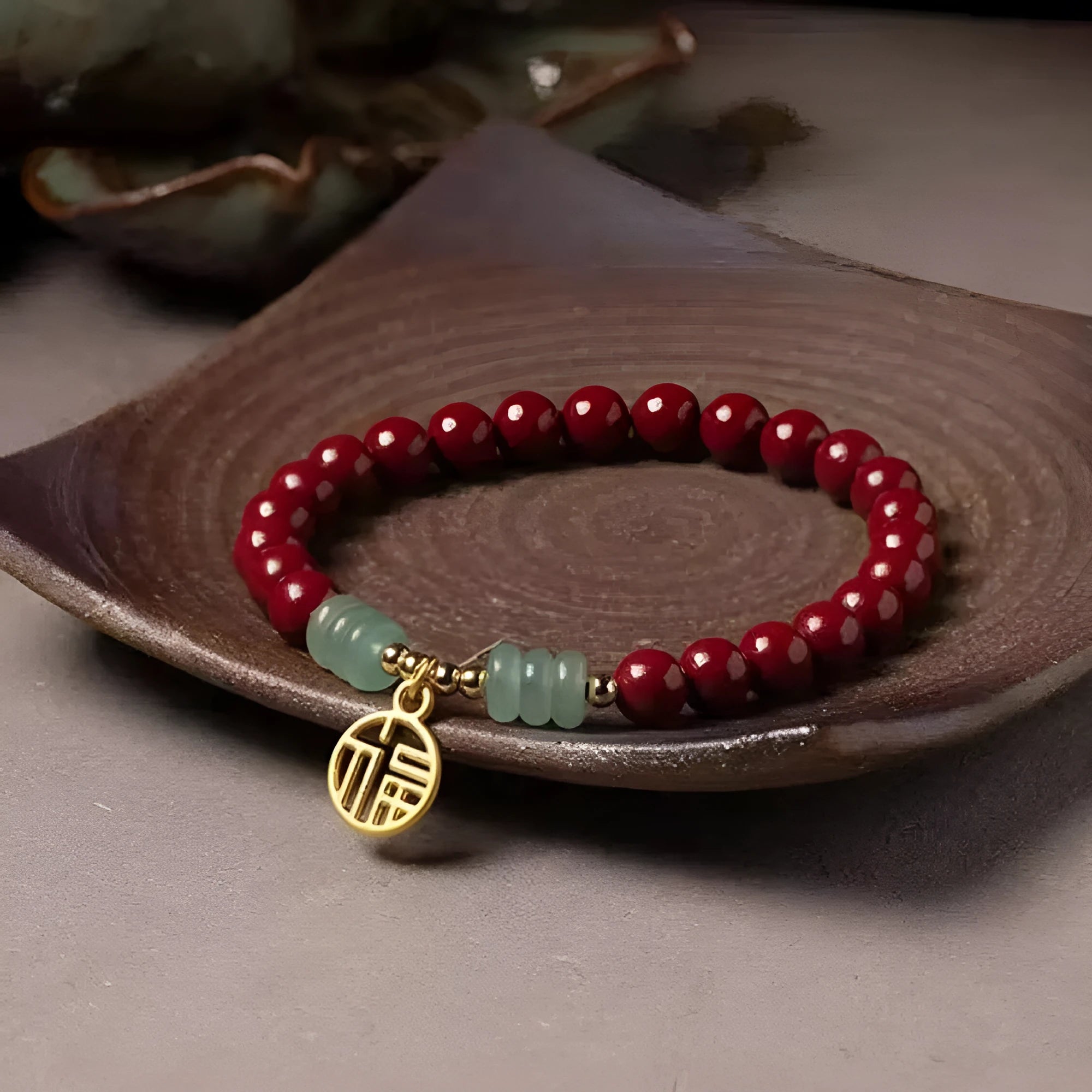 Close-up of a handcrafted wave-pattern bracelet made from red cinnabar and copper beads.
