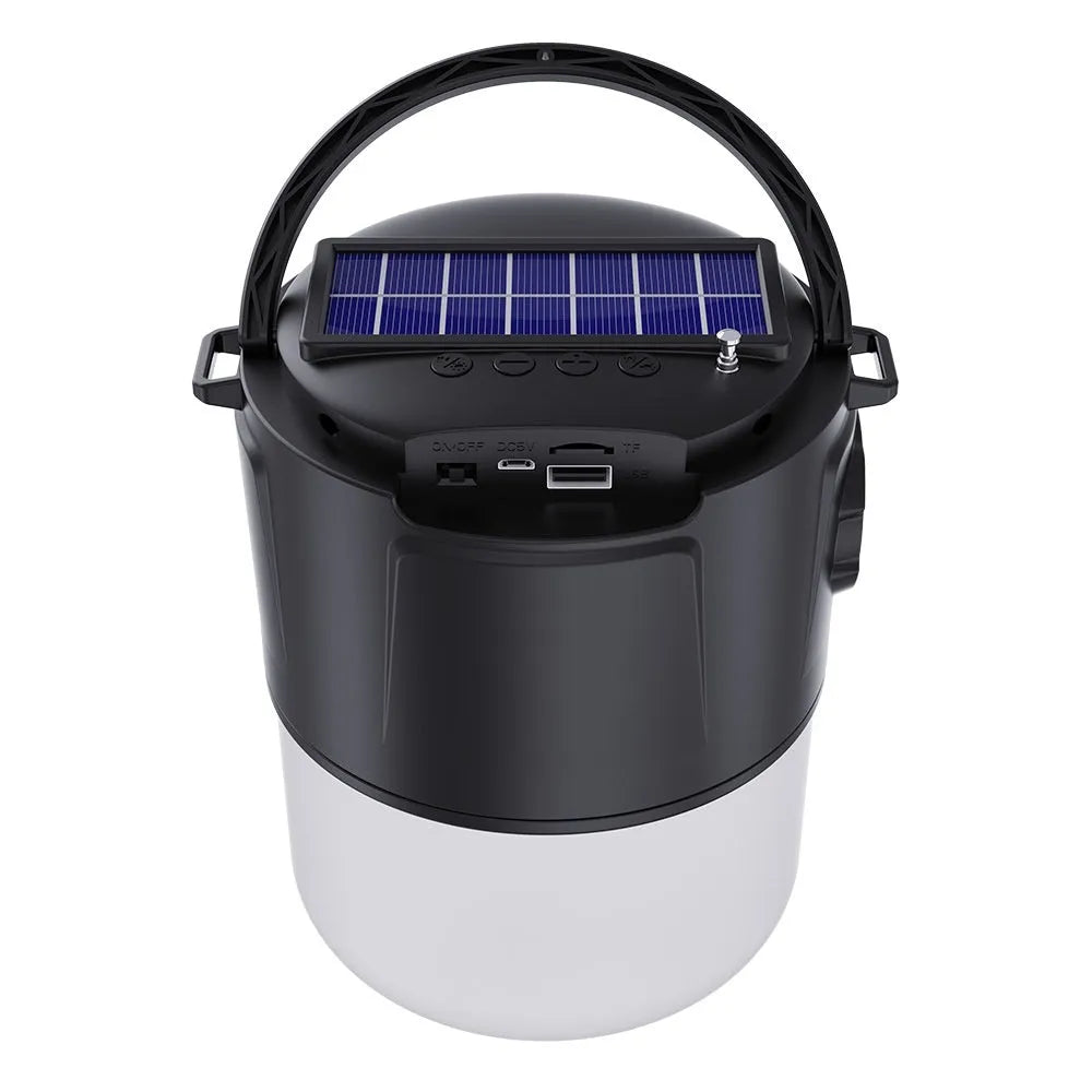 Portable solar camping lantern speaker with Bluetooth, LED light, USB rechargeable, black colour, on outdoor lawn
