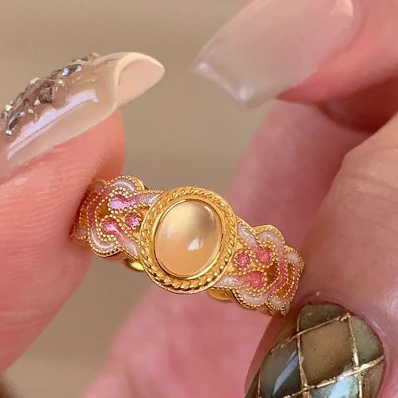 Pink crystal enamel geometric open-mouth ring on a gold-plated copper band.