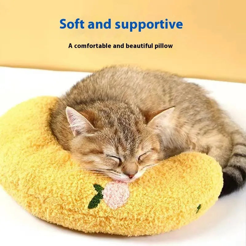 Blue and yellow U-shaped cloth pillows for cat neck support in moon and question mark designs.