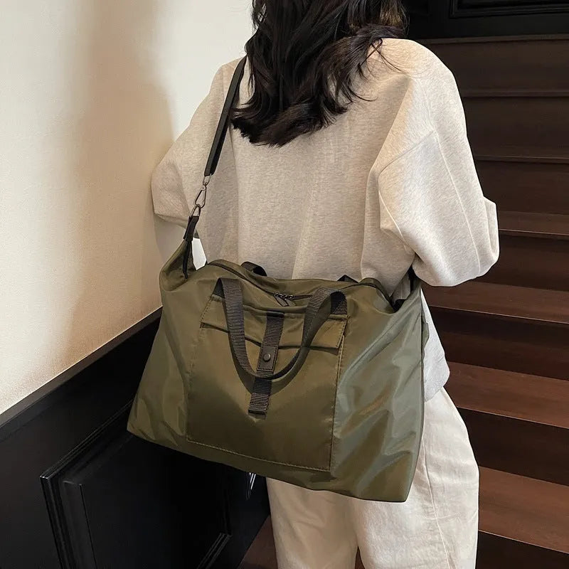Grey one-shoulder travel bag with large 36-55 litre capacity and Oxford cloth construction