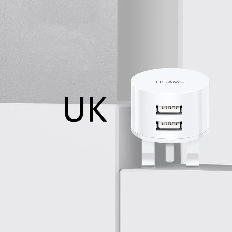 White portable USB phone charger with built-in US EU UK adapter plugs showing compact dimensions
