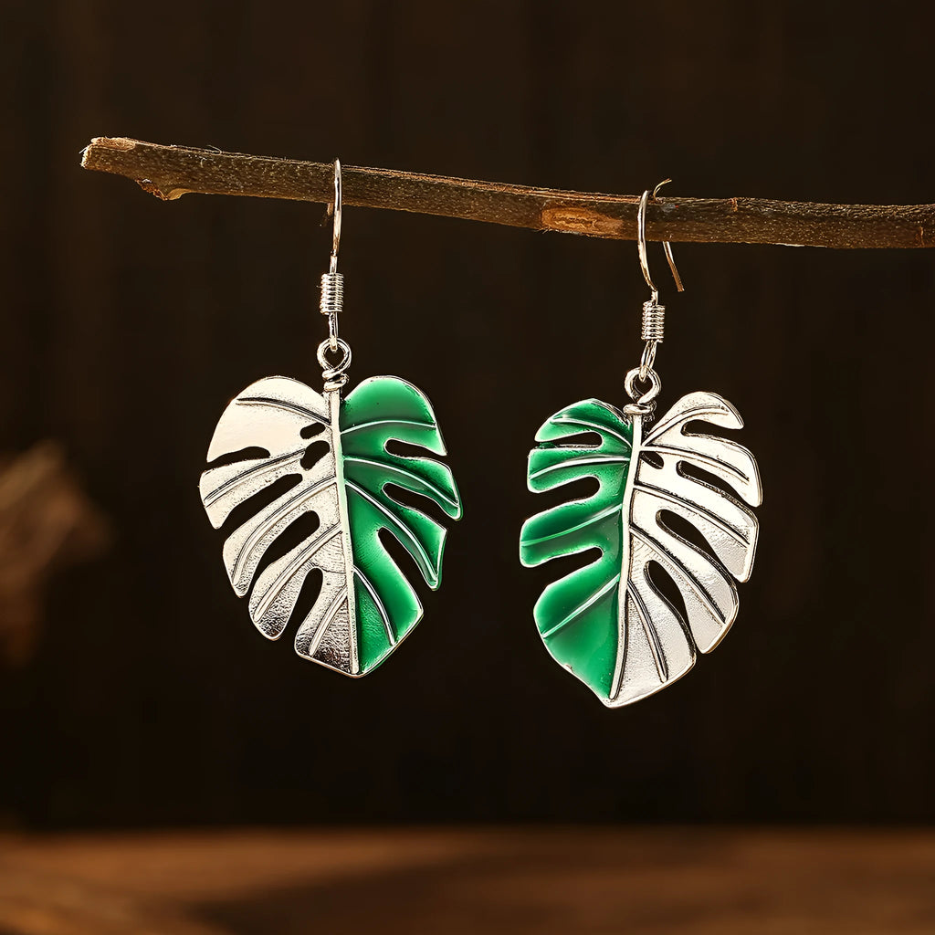 Silver alloy leaf-shaped drop earrings for women on white background