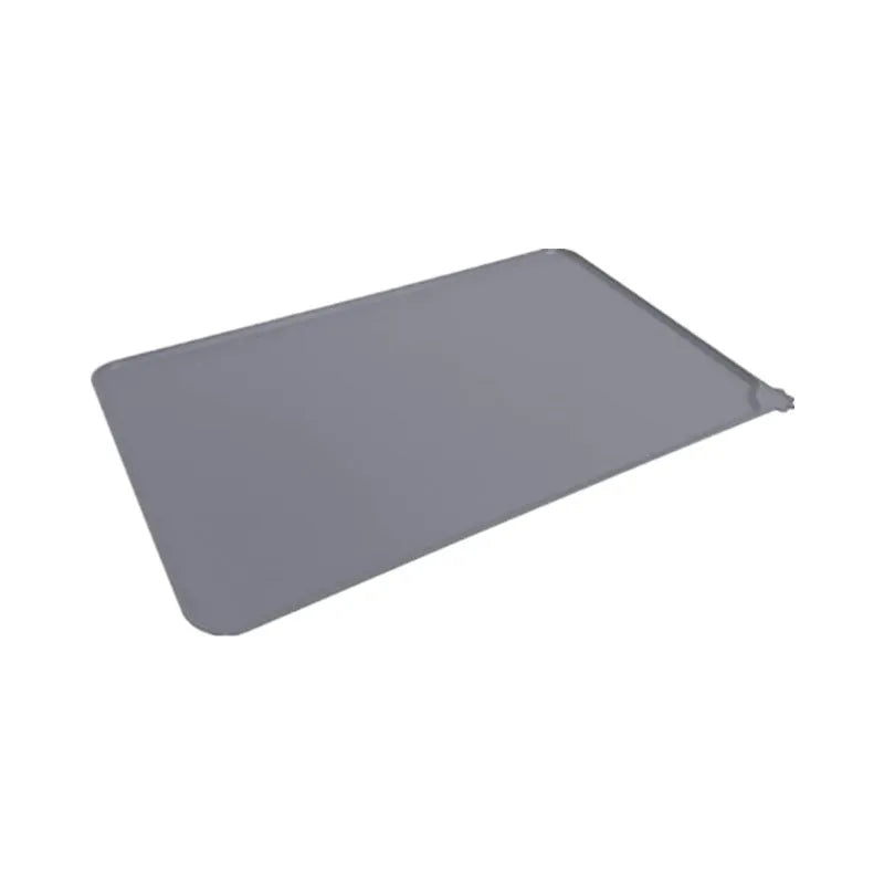 Silicone pet placemat under dog food and water bowls in a grey colour on a wooden floor.