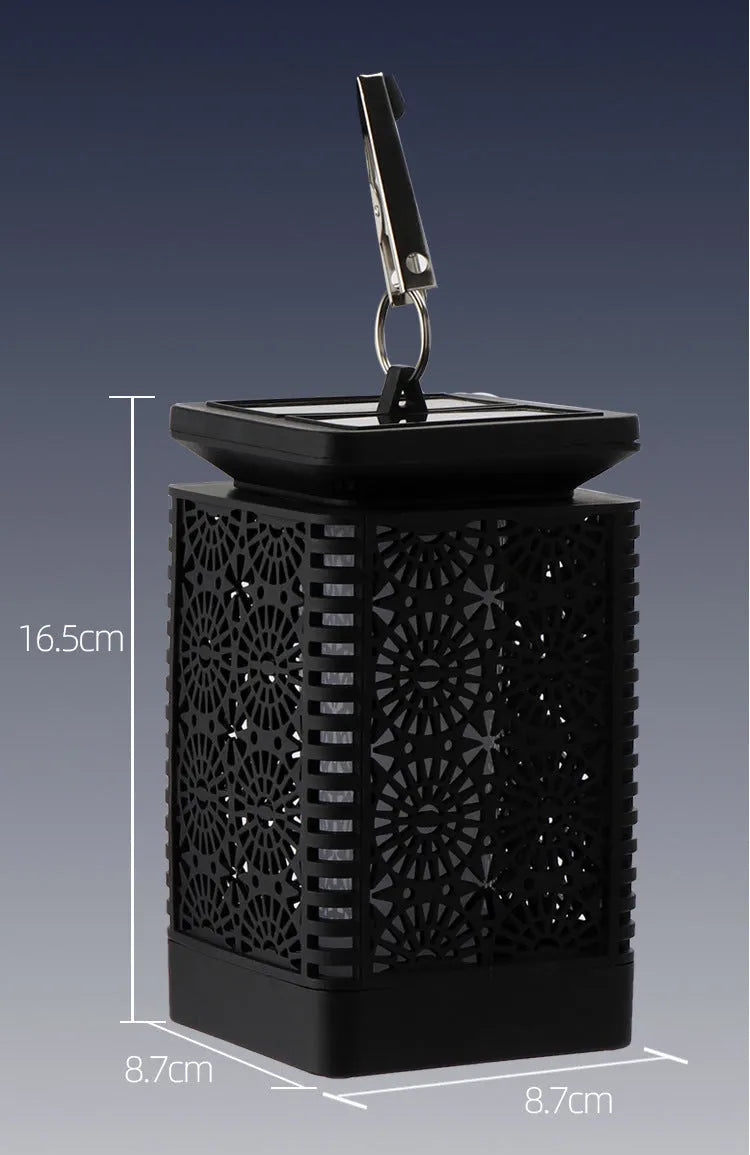 Grey retro-style solar lawn light with flame effect LED, placed in a garden.