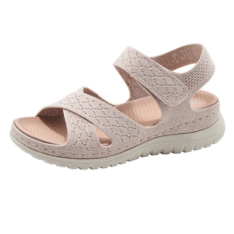 Plus size flat sandals in apricot with Flyknit upper, PVC sole, and Velcro strap.