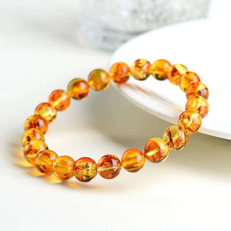 Natural yellow piebald amber bracelet with flower spot patterns and polished geometry beads