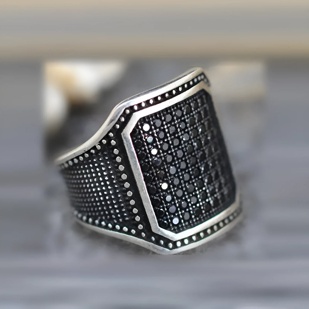 Black alloy ring with copper geometric inlay and cubic zirconia stones