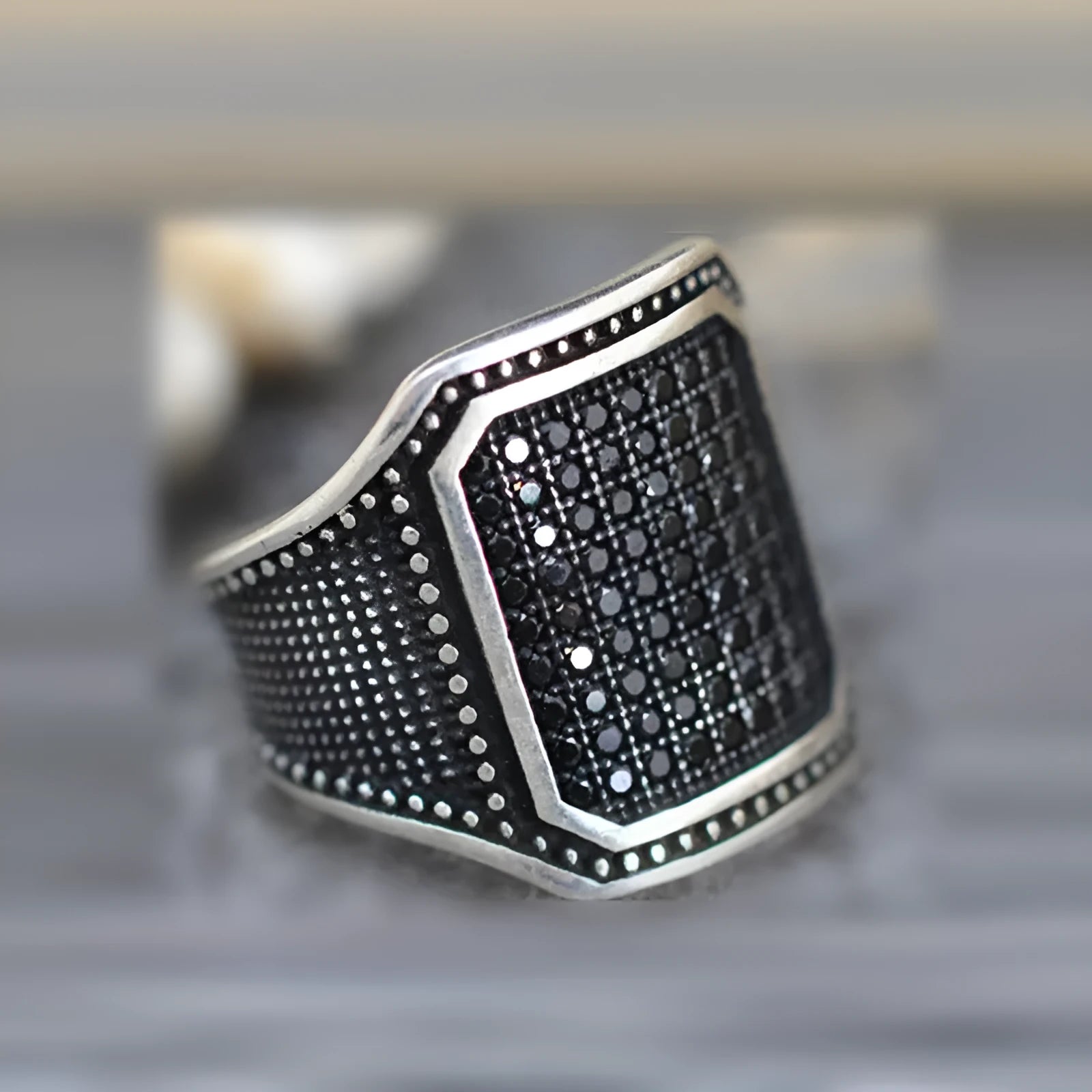 Black alloy ring with copper geometric inlay and cubic zirconia stones