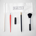 Scratch painting tools set with white card, 14.5cm long tool, brushes, and photo frames on a table.