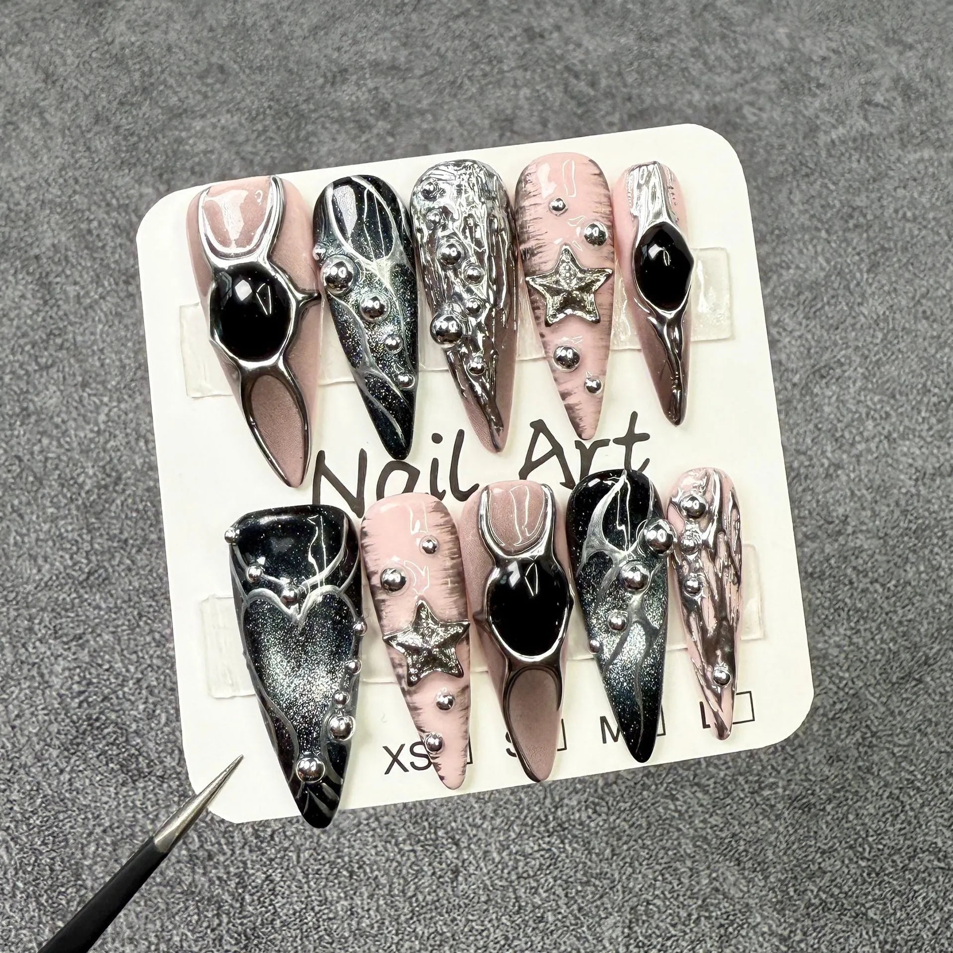Set of long pointed dyed nails with metal hand-painted relief and cat eye finish in multiple sizes