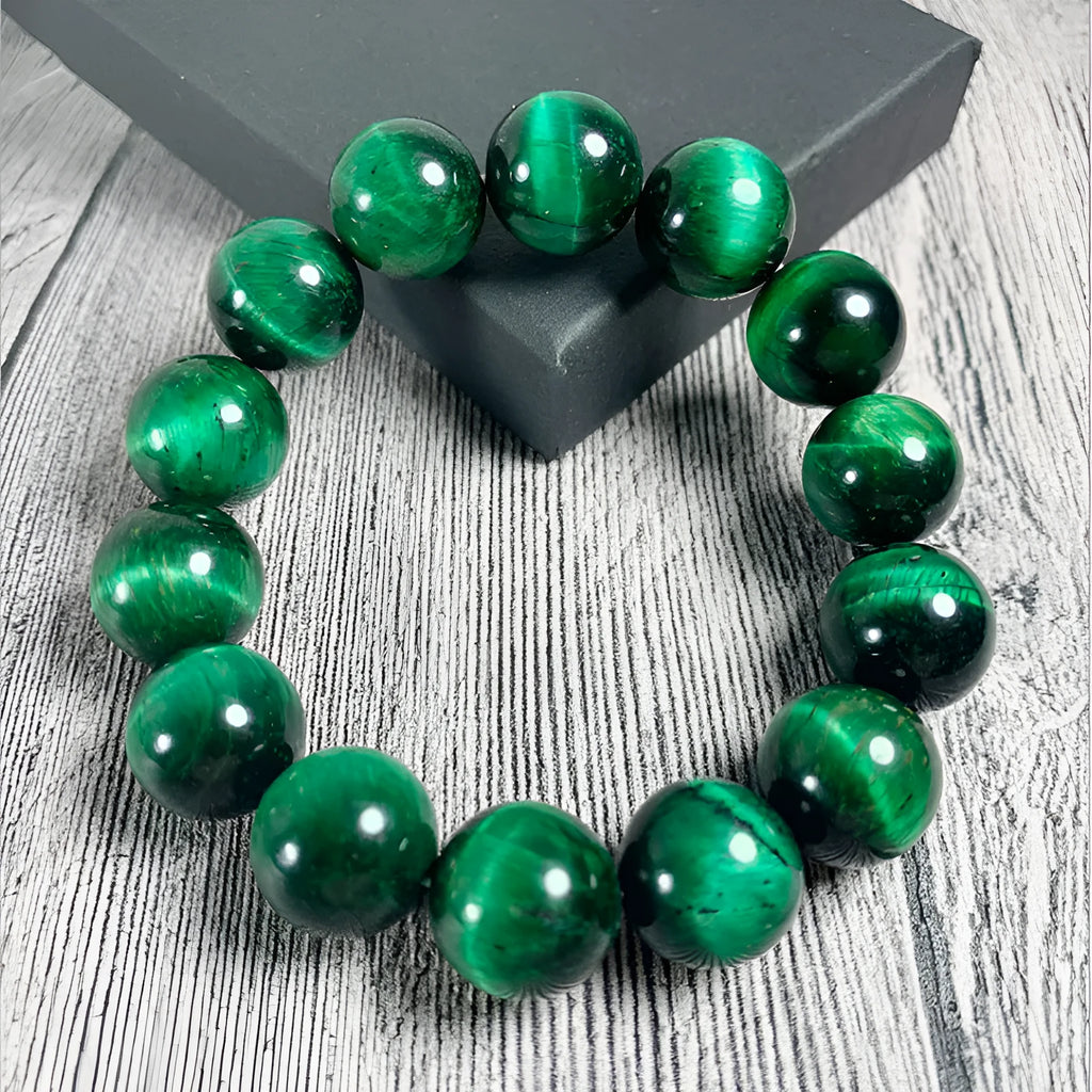 Green Tiger Eye stone bracelet with polished geometry beads on a wrist.