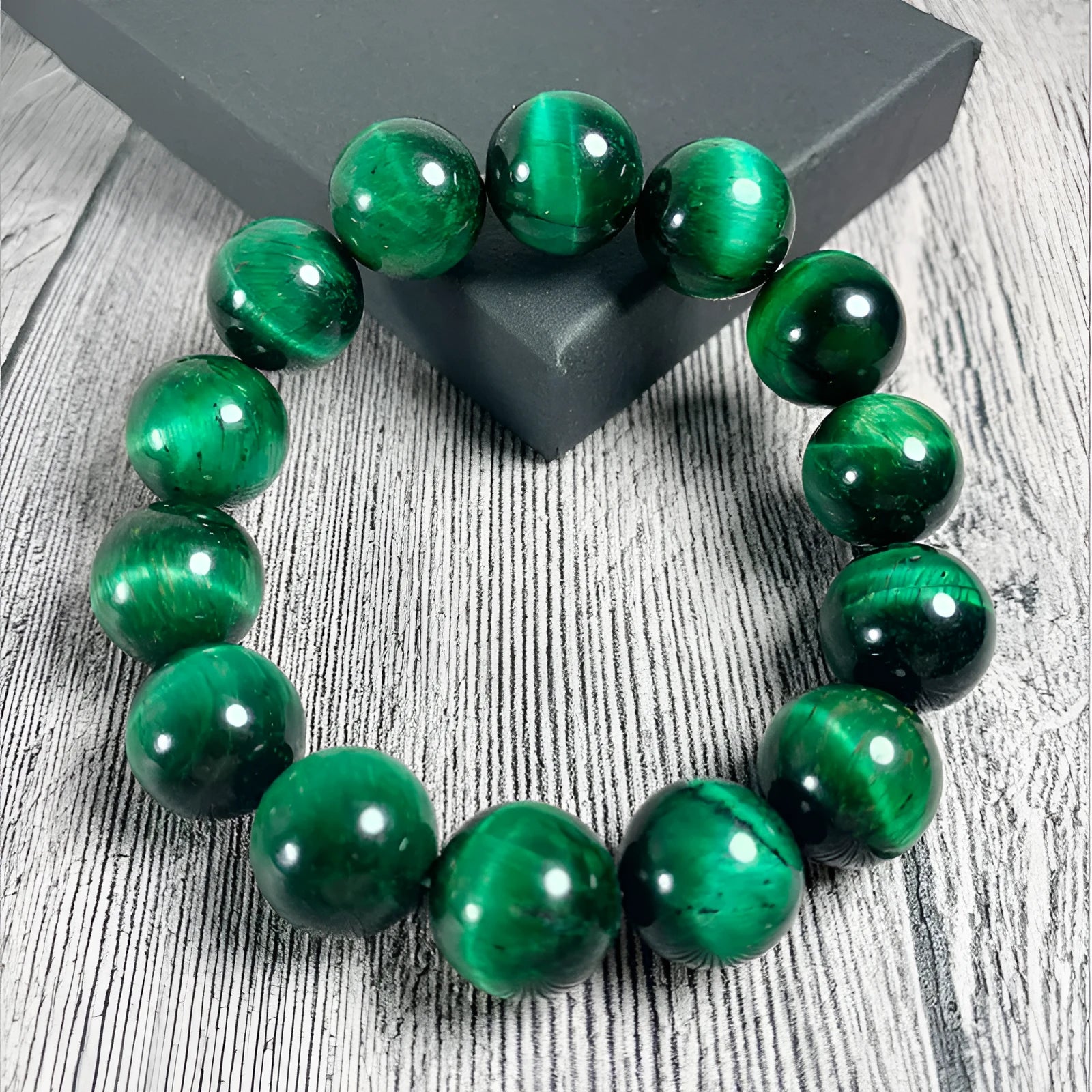 Green Tiger Eye stone bracelet with polished geometry beads on a wrist.