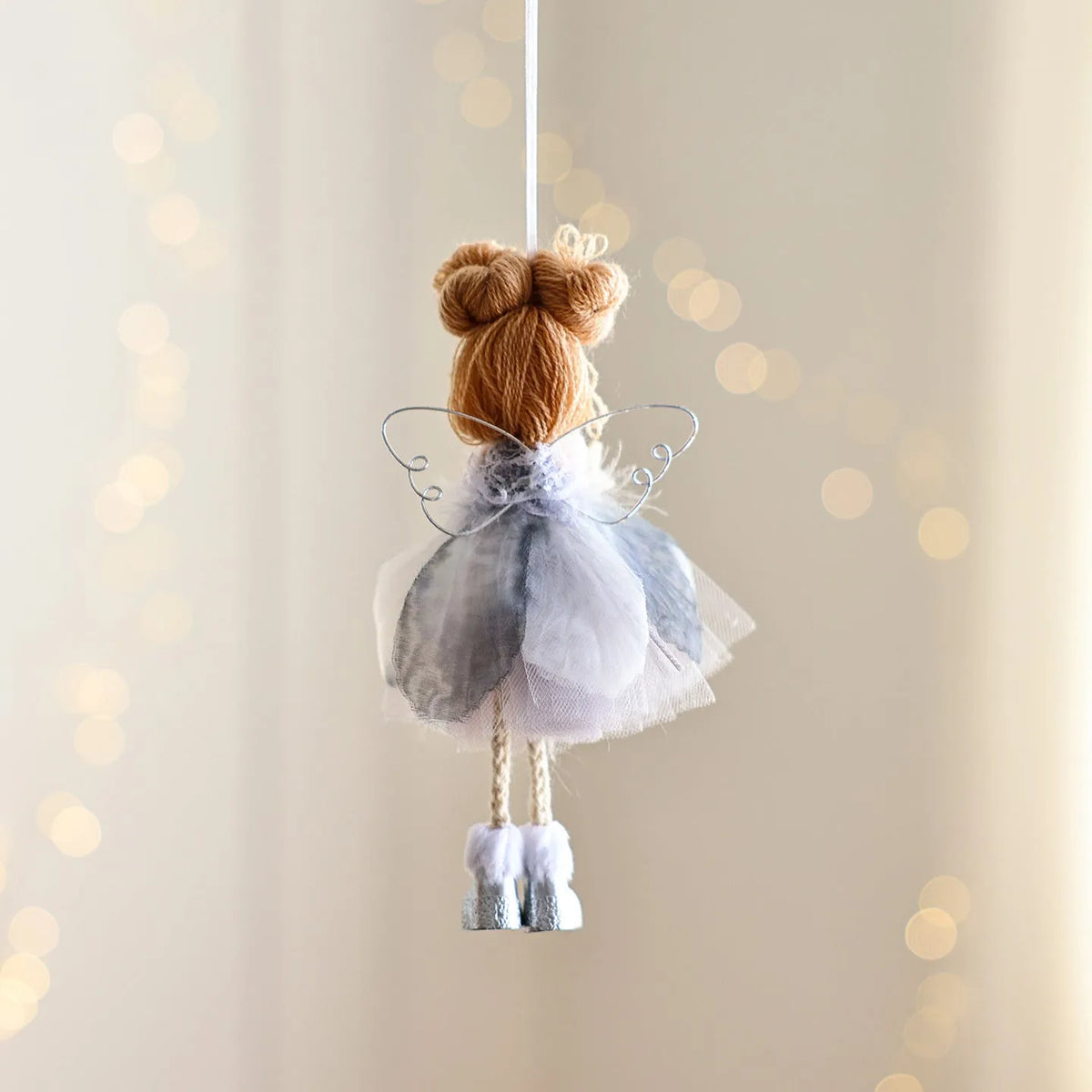 White Christmas tree hanging ornament with mesh angel girl design, snowflake styling, and metal, plastic, and cloth construction.