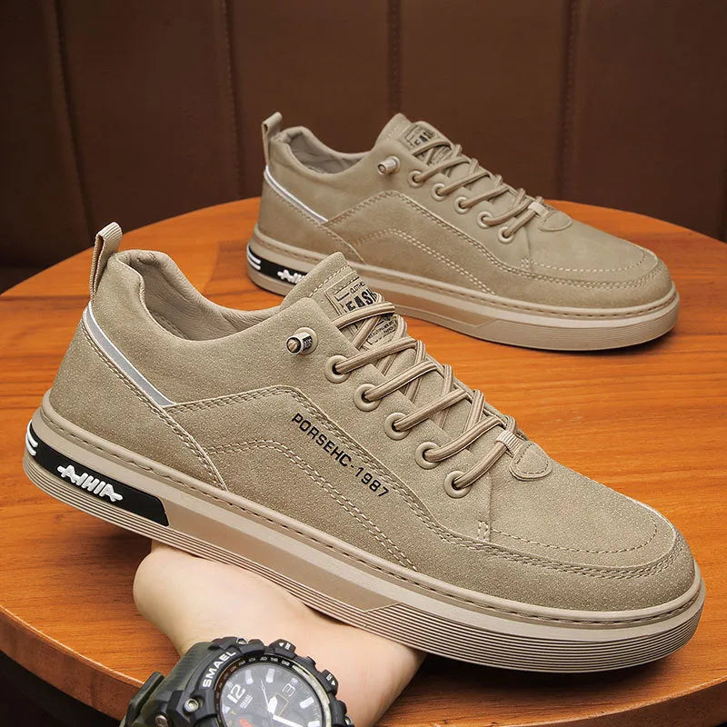 Men's khaki casual work shoe with round toe, low top, and rubber sole on a plain background.