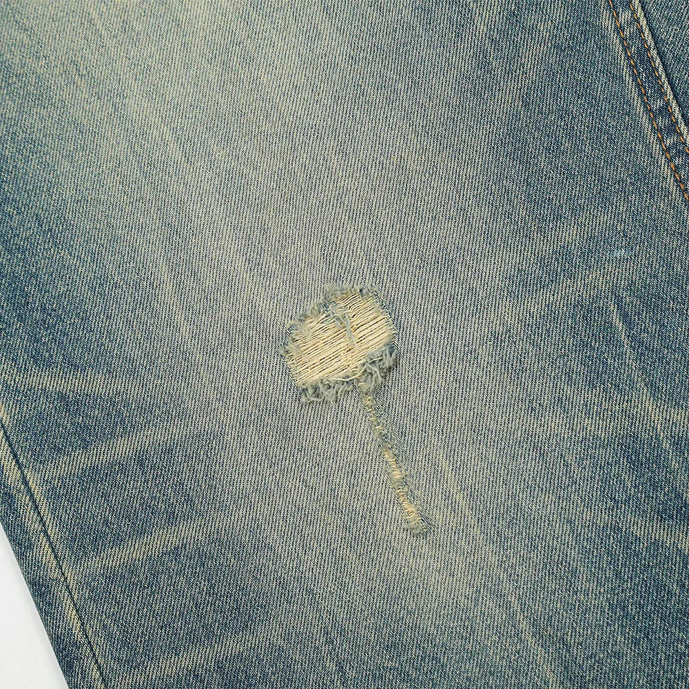Retro distressed jeans for men in vintage blue cotton denim with worn-in finish, front view