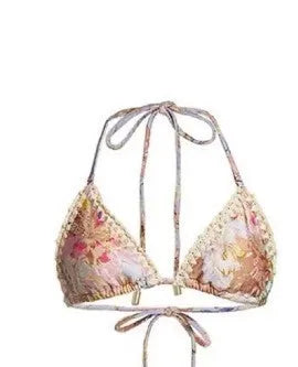Women's creamy white floral bikini set with top, briefs, and matching skirt on a mannequin.