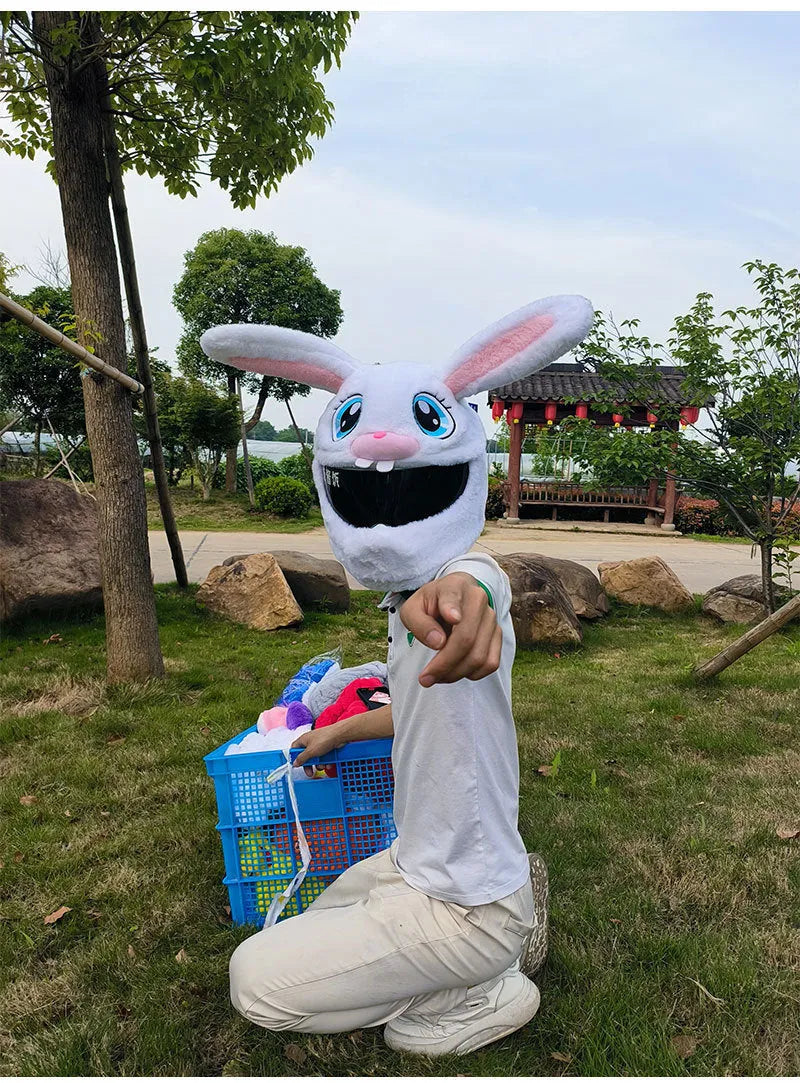 White plush rabbit head cover with long ears designed for an electric motorcycle helmet.