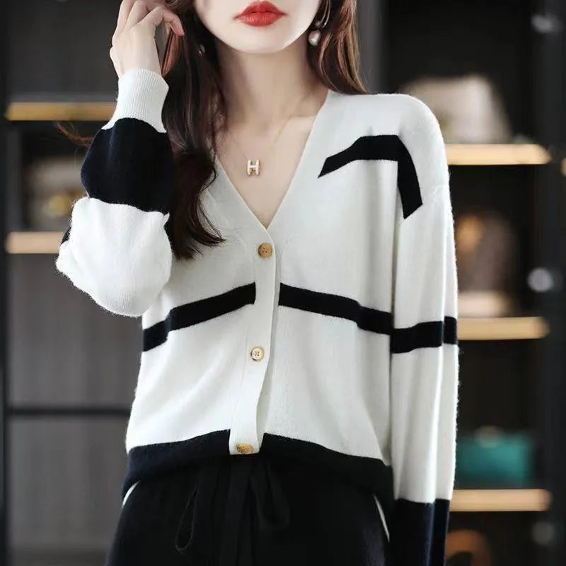 Women's black and white striped knitted cardigan with 3D pattern and V-neck.