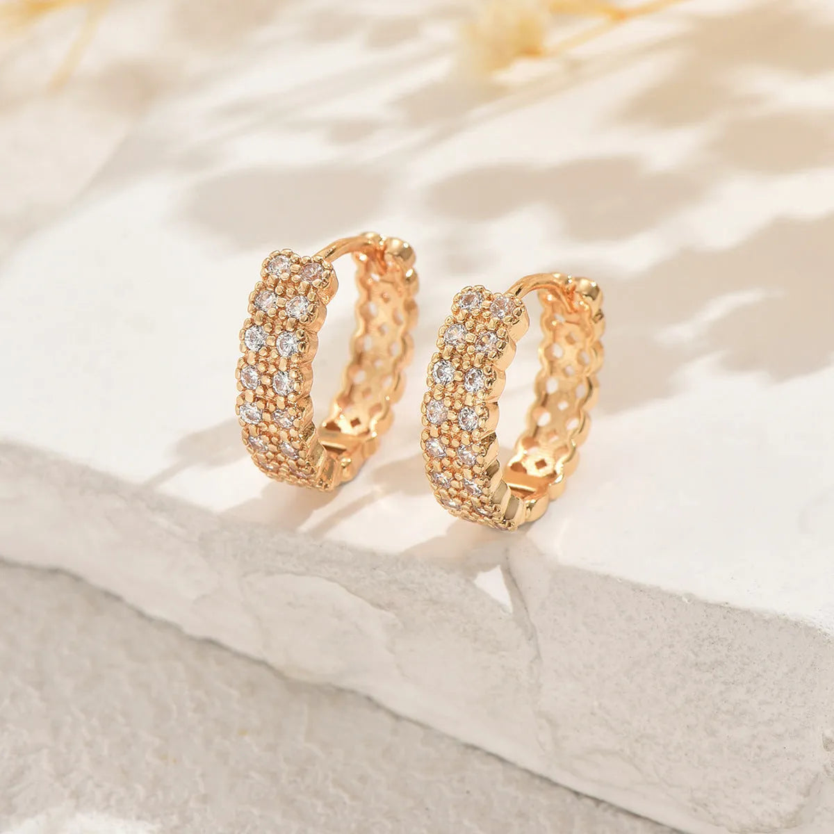 Geometric copper ear studs with round, dot, and ring pattern elements in colour DE20288