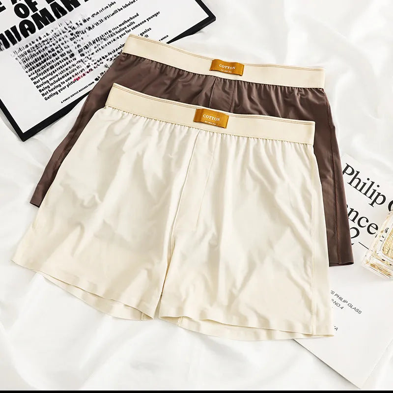 Men's solid colour loose fit ice silk boxer shorts on a mid waist, shown in dark grey.