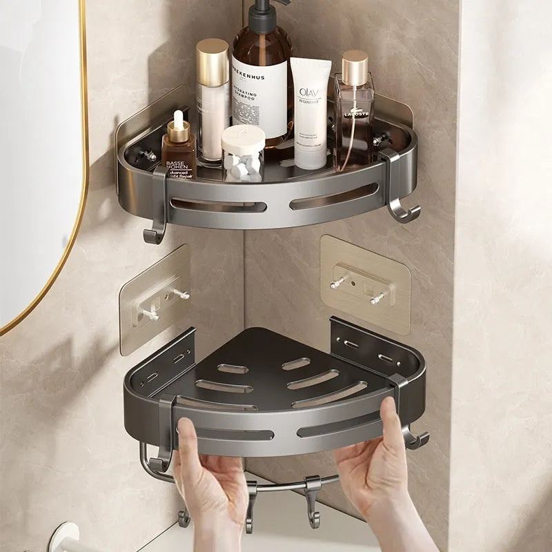 Gun grey metal fan-shaped corner bathroom shelf mounted punch-free on a wall, holding bathroom toiletries.