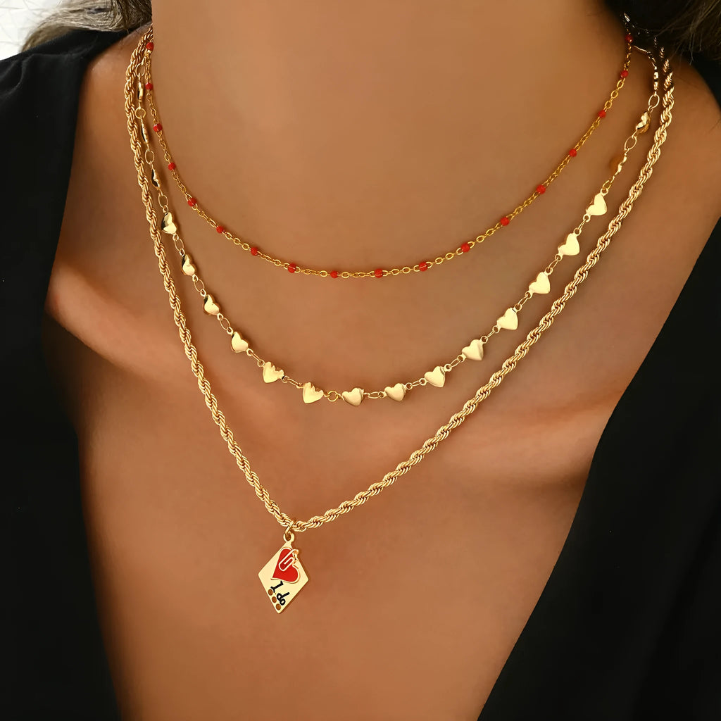 Gold tone three-layer love necklace with geometric pendant on a model.