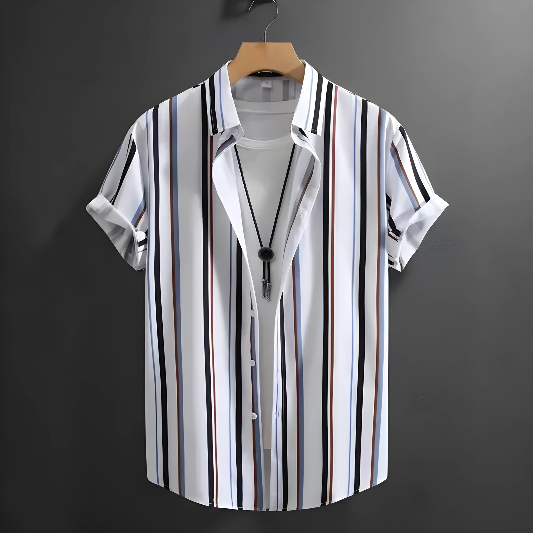 Man wearing a loose-fitting striped short sleeve shirt with a stand collar.