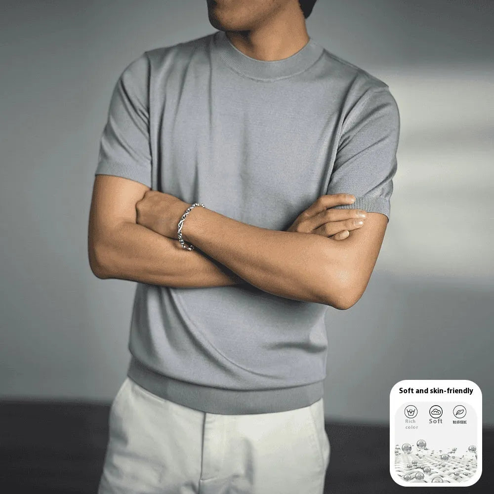 Man wearing a silver grey knitted round neck t-shirt with short sleeves.