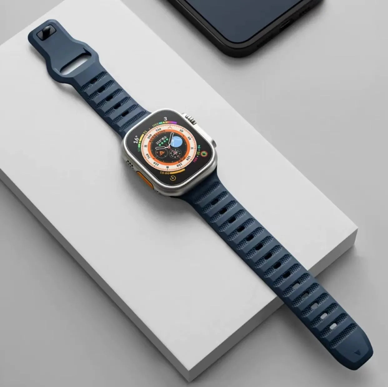 Fluoro rubber Apple Watch replacement strap with T buckle in one of six colours on a wrist.