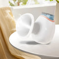 White and purple portable eye humidifier with USB charging cable on white background