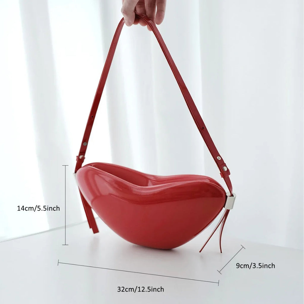 Red heart shaped crossbody bag in solid PU synthetic leather with single shoulder strap and sandwich pocket