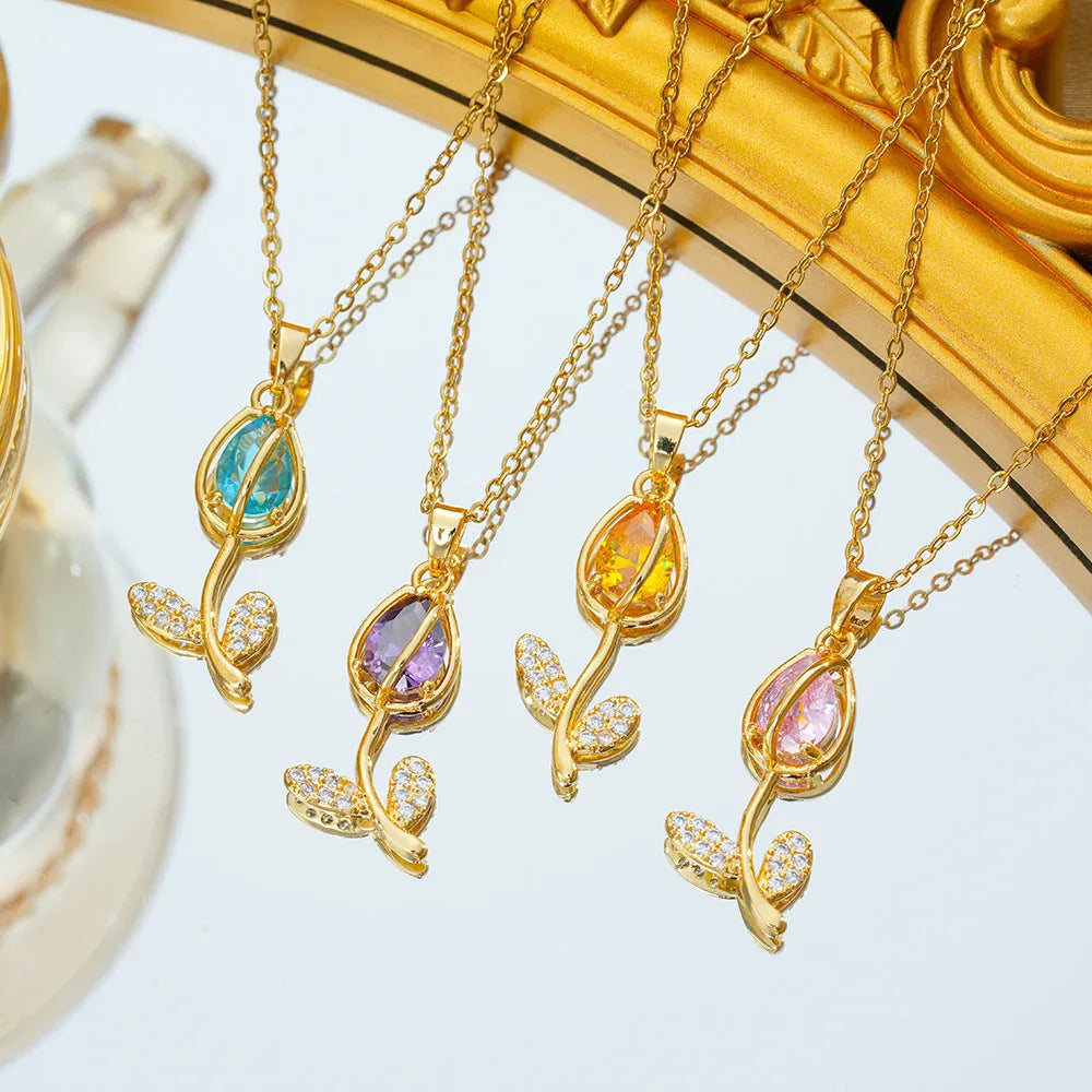 Gold-coloured tulip flower necklace on an adjustable O‑ring chain, shown in one of five colour options.