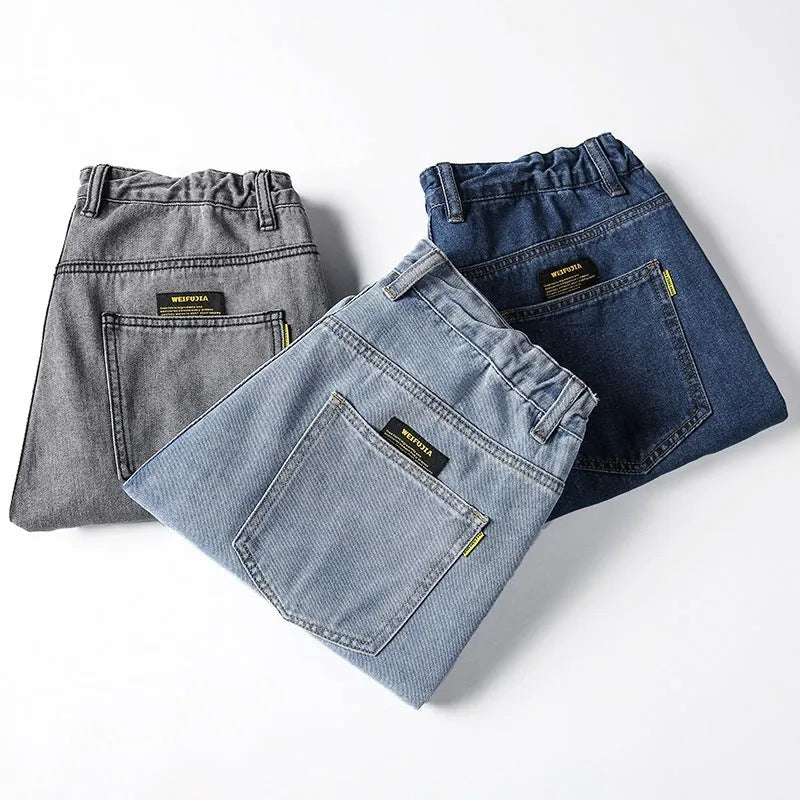 Men's loose fit straight leg casual jeans in dark blue, shown on a hanger.