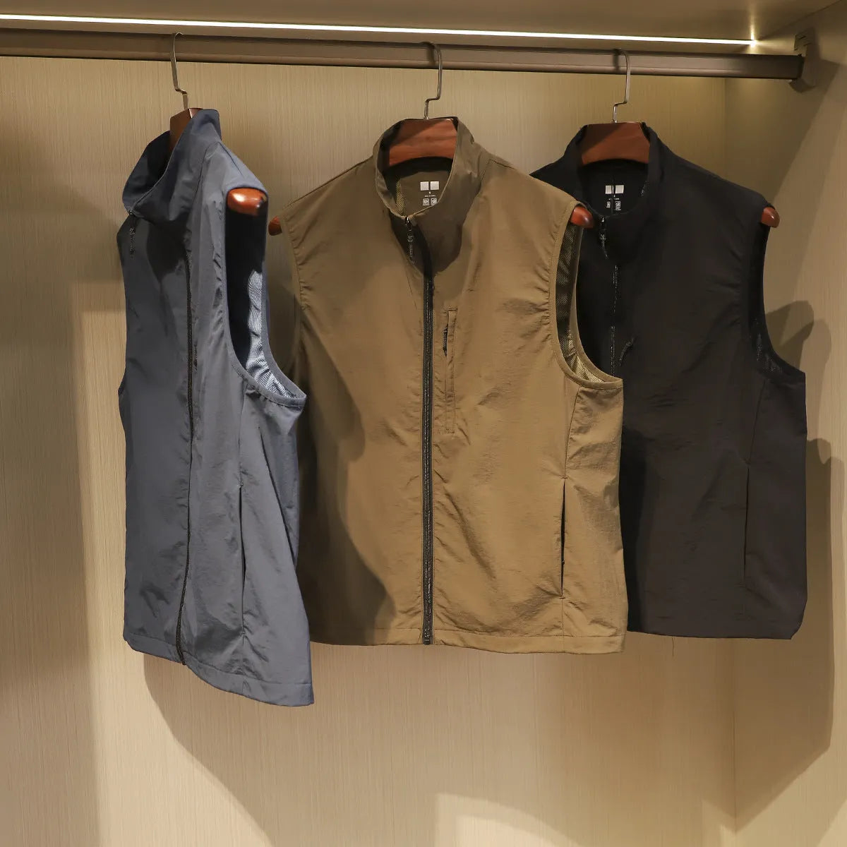 Men's straight cut thin nylon vest cardigan in army green with side seam pockets.