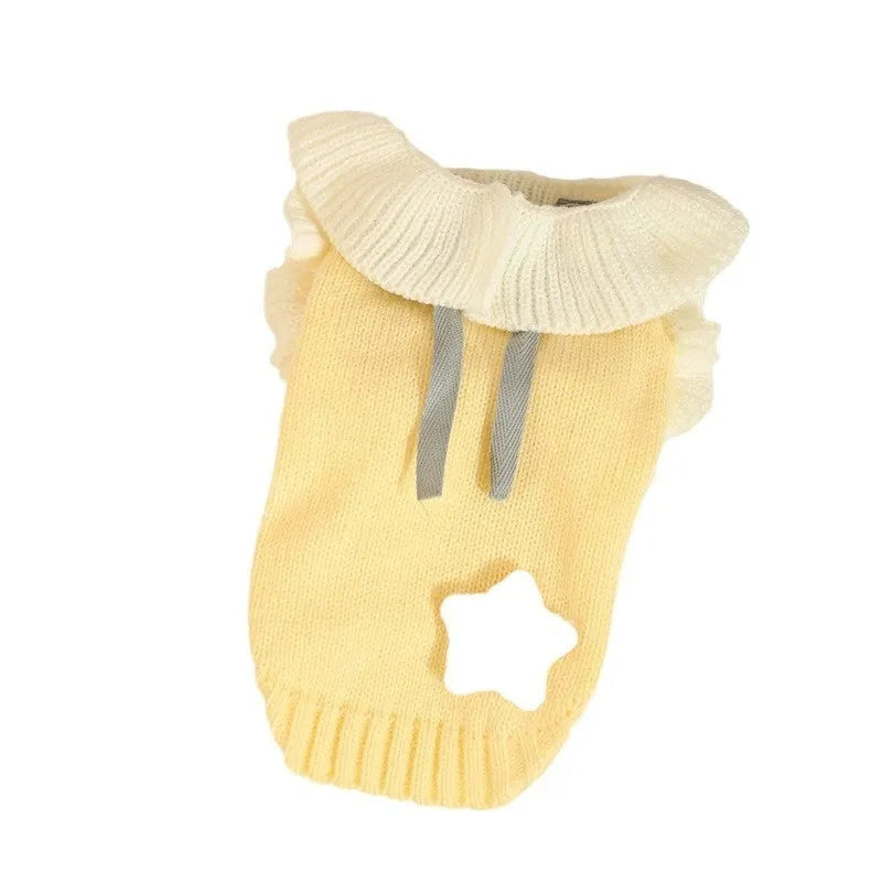 Yellow XINGX pattern acrylic dog sweater on a small dog, showing casual knitwear style.