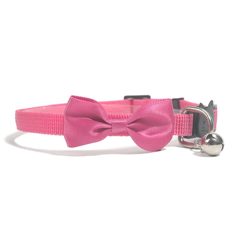 Adjustable nylon cat collar with decorative bow and bell in striped cartoon pattern, multiple colour options shown