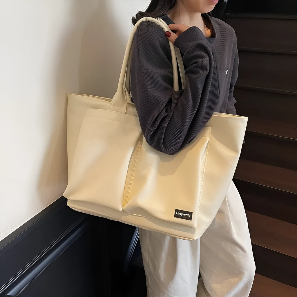 Lightweight expandable PU shoulder bag in black, shown with adjustable strap and sporty design.