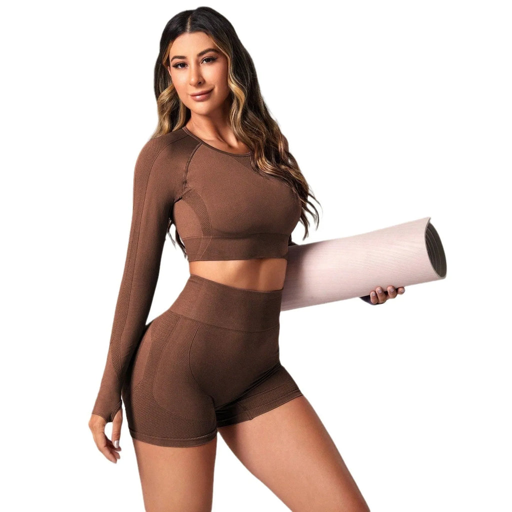 Women's black yoga suit set with long sleeve top and high-waist tight leggings laid flat.