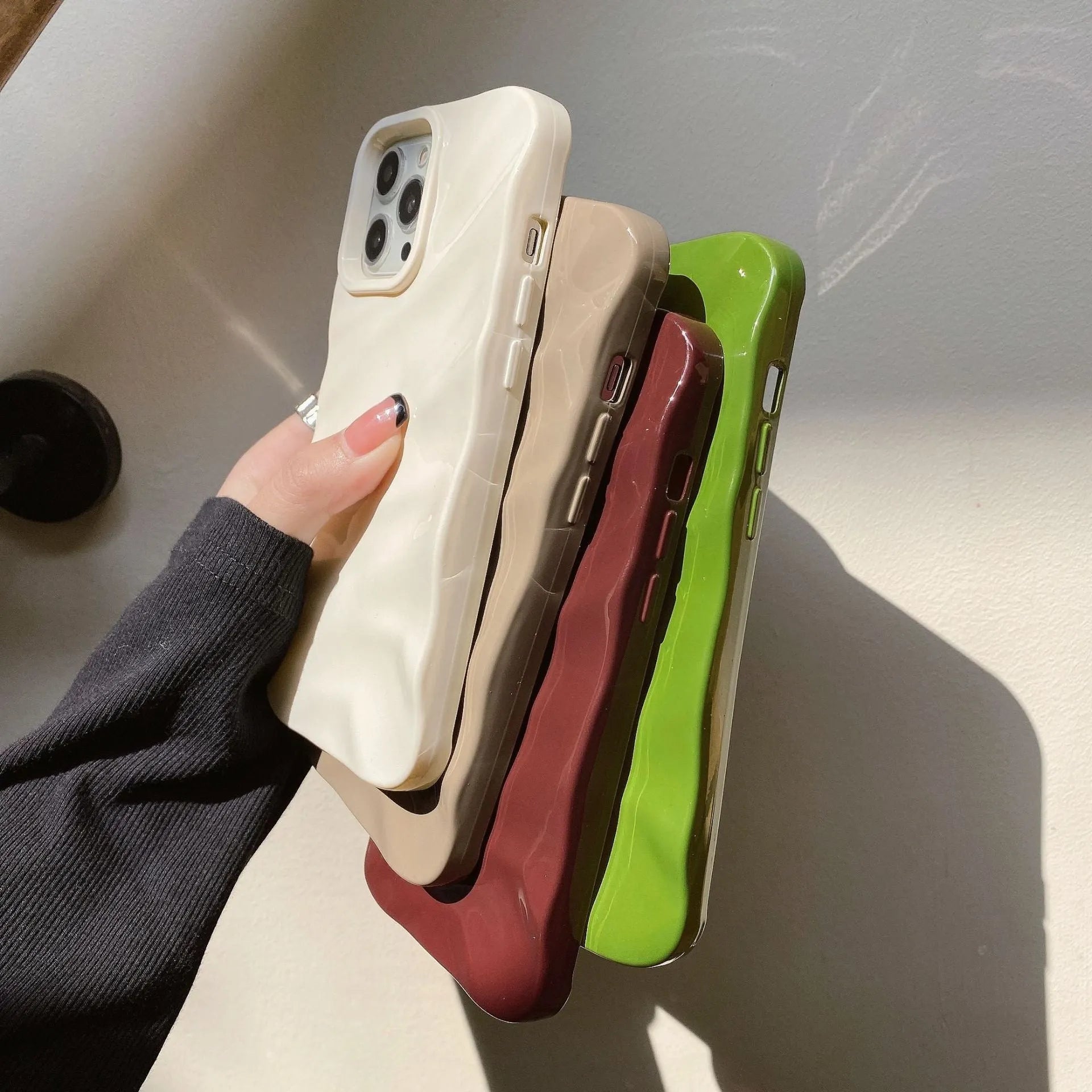 Soft solid colour wave pleated TPU protective case for Apple iPhone 17 series in burgundy on a white background.