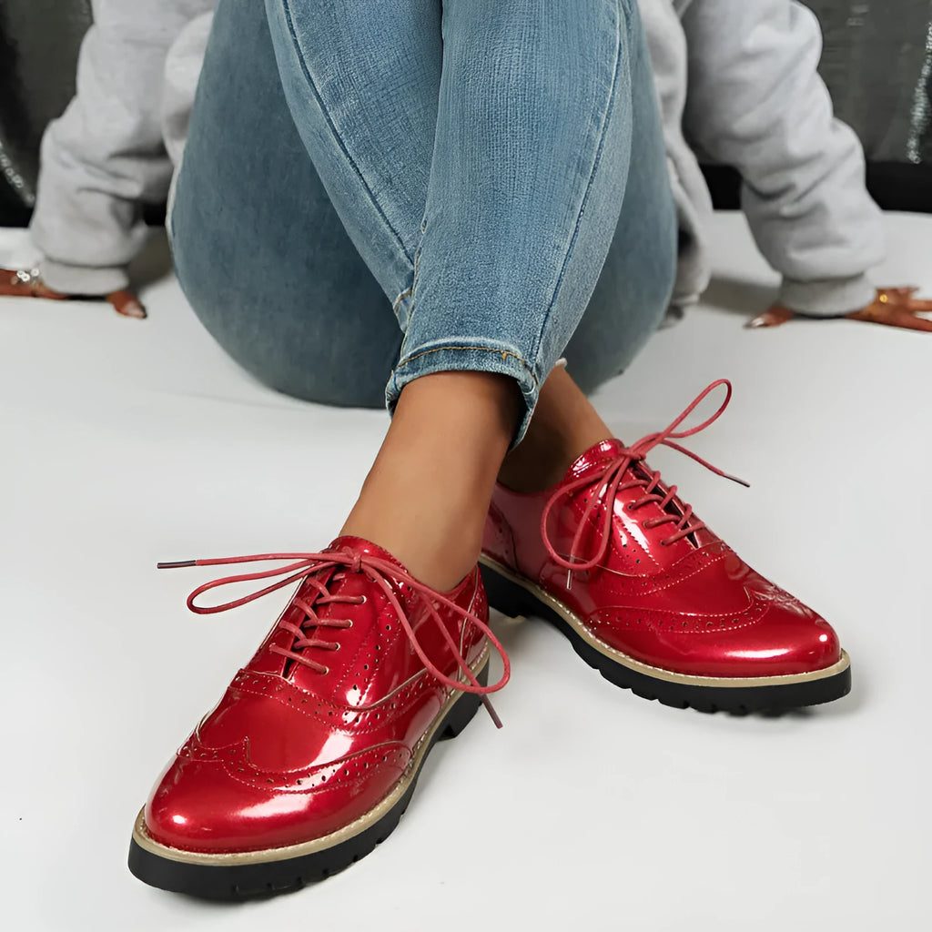 Women's black sequined lace-up loafers with a wedge heel and round toe, shown on a mid-calf.