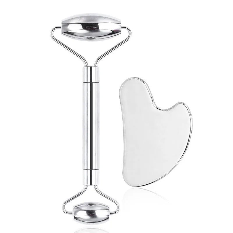 Stainless steel double-headed facial roller, heart-shaped acupressure stick, and scraping plate on a white background.